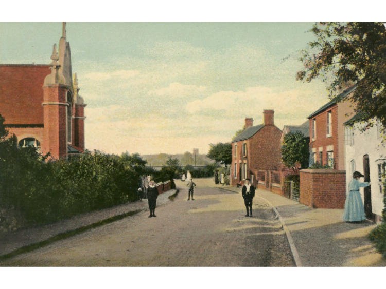 Hand-coloured postcard of the street with figures walking.