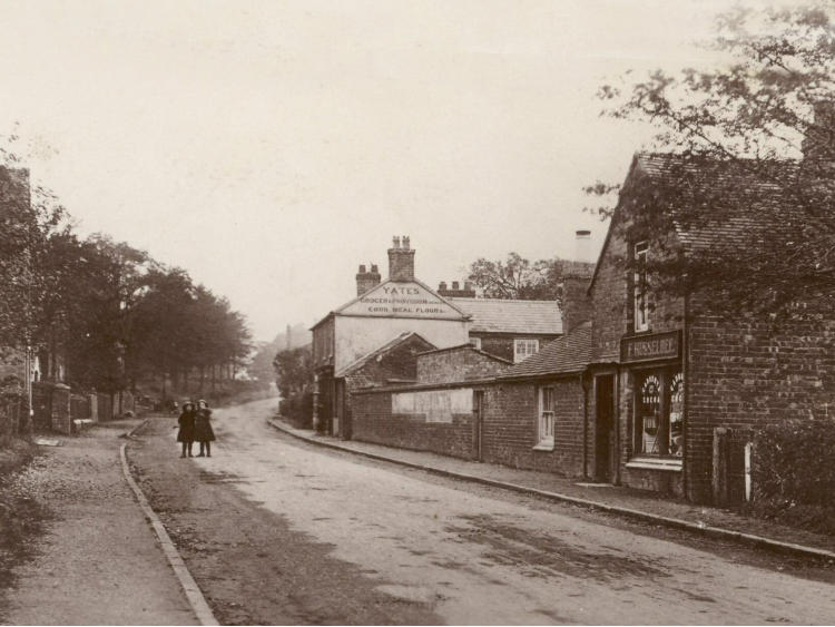 Buildings along the road, in sepia.