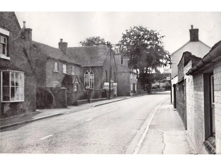 A narrow street running between cottages.