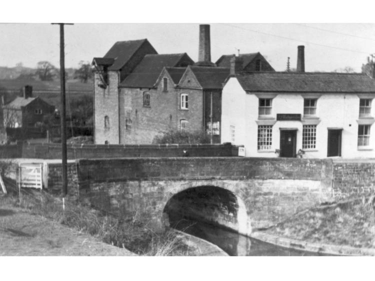 The canal bridge with buildings behind.