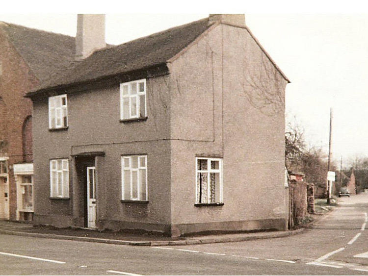 Pink rendered house on a corner.