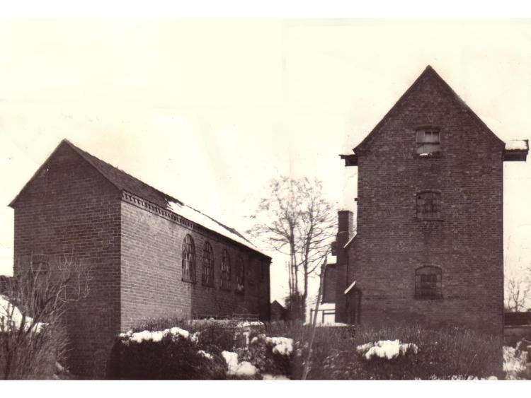 Brick gable ends beside a wall.
