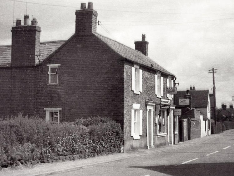 A pair of cottages beside the road.