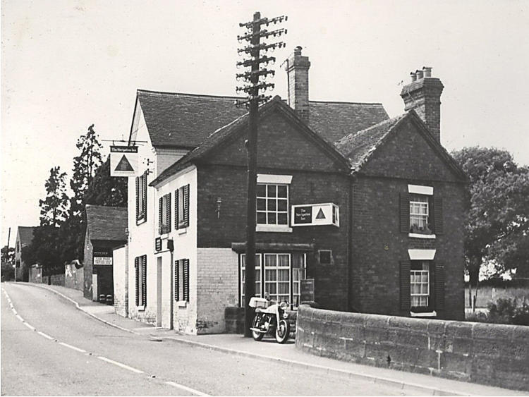 The Navigation and neighbouring buildings, a motorbike outside.