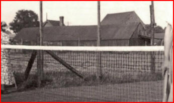 The old Stacey timber workshop behind a fence.